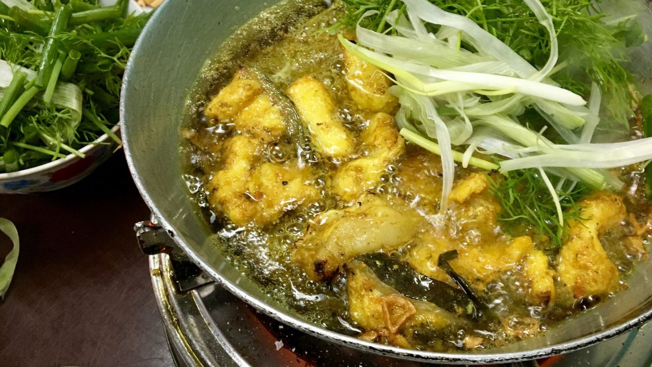 There's a street in Hanoi that's entirely dedicated to chả cá -- a vermicelli noodle dish with turmeric-spiced catfish that diners grill themselves.